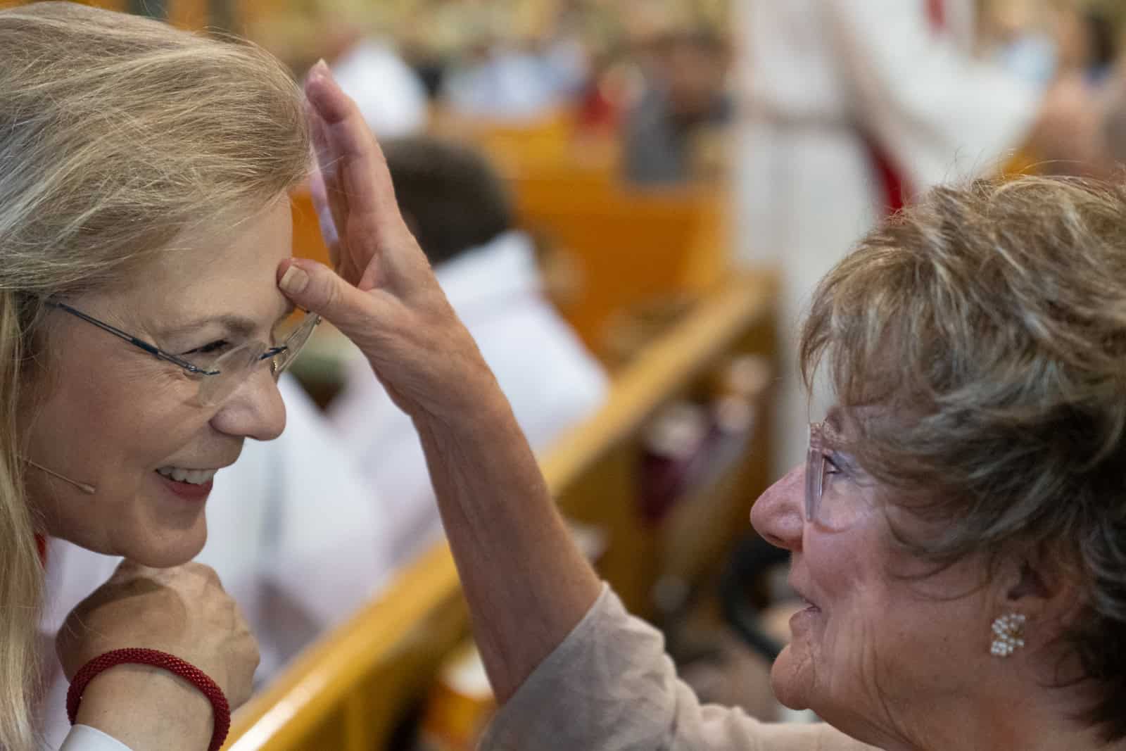 Two women sharing a joyful moment at Incarnation Lutheran Church, highlighting community, faith, and fellowship.