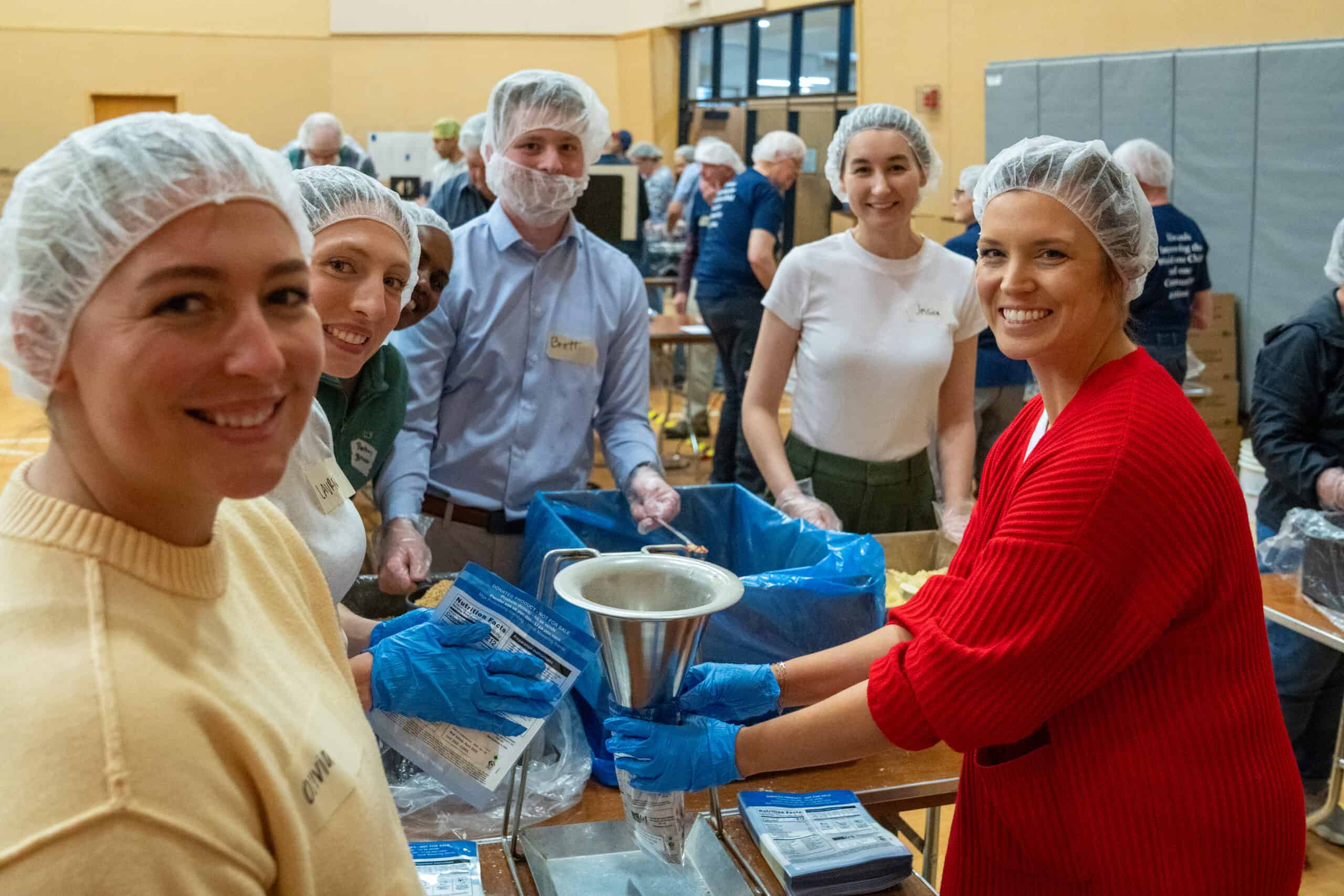 Group of volunteers packing food at Incarnation Lutheran Church food drive event.