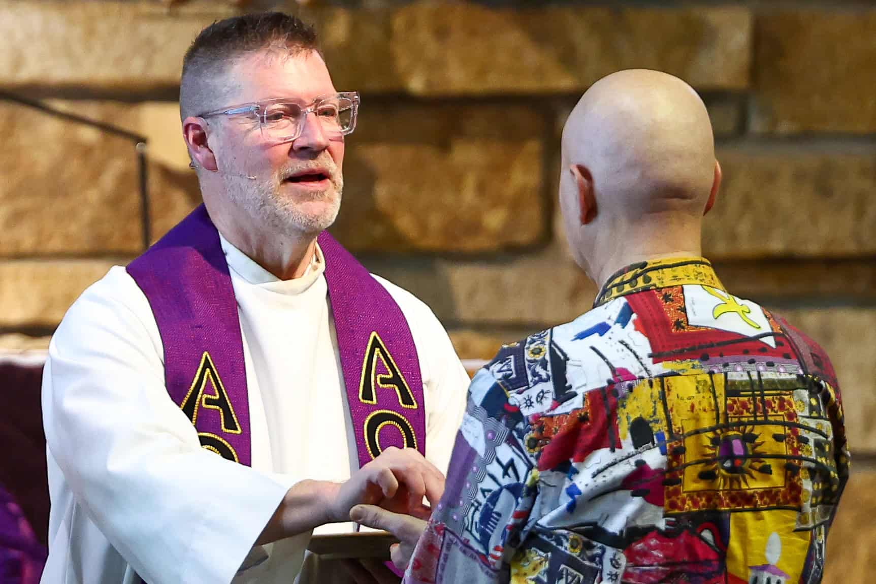 Incarnation Lutheran Church Community Event A priest at Incarnation Lutheran Church shaking hands with a young person during a community event, highlighting faith and inclusion.