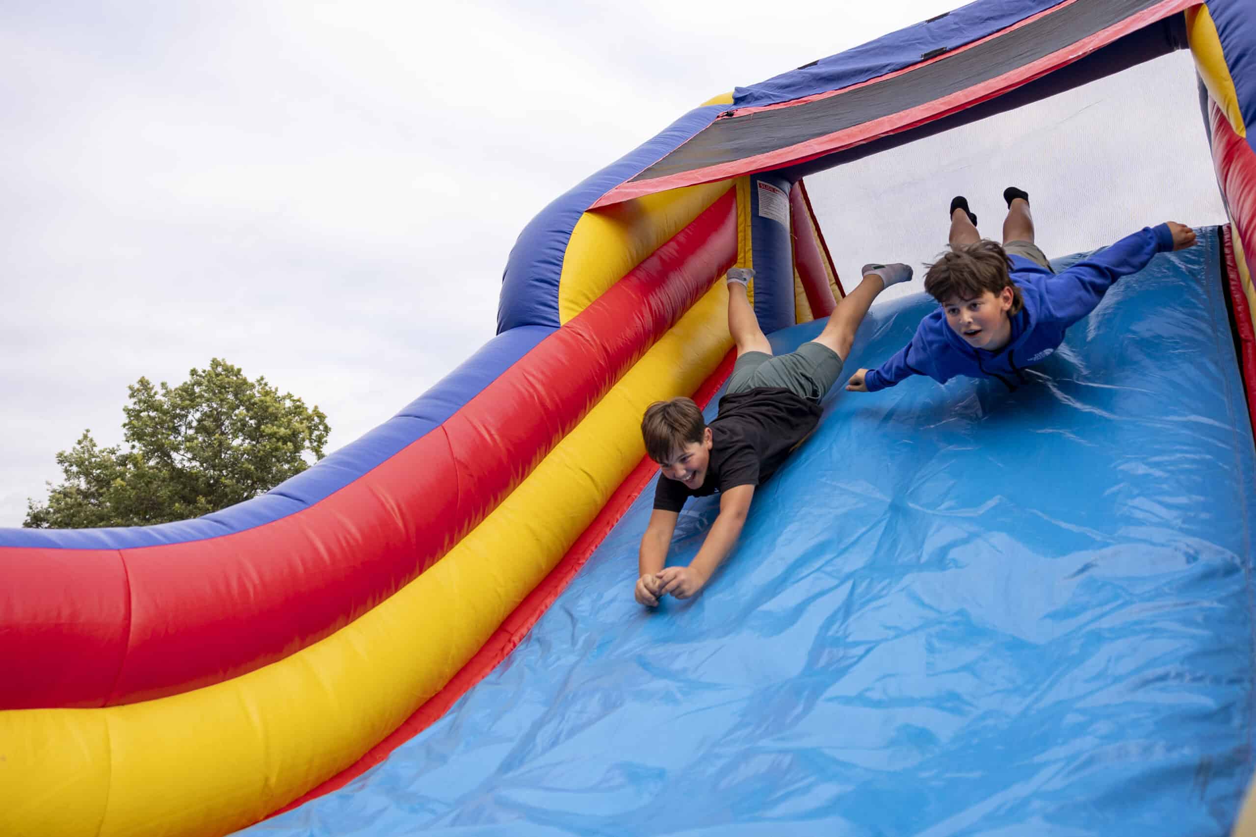 Children playing on a colorful inflatable slide at Incarnation Lutheran Church event.