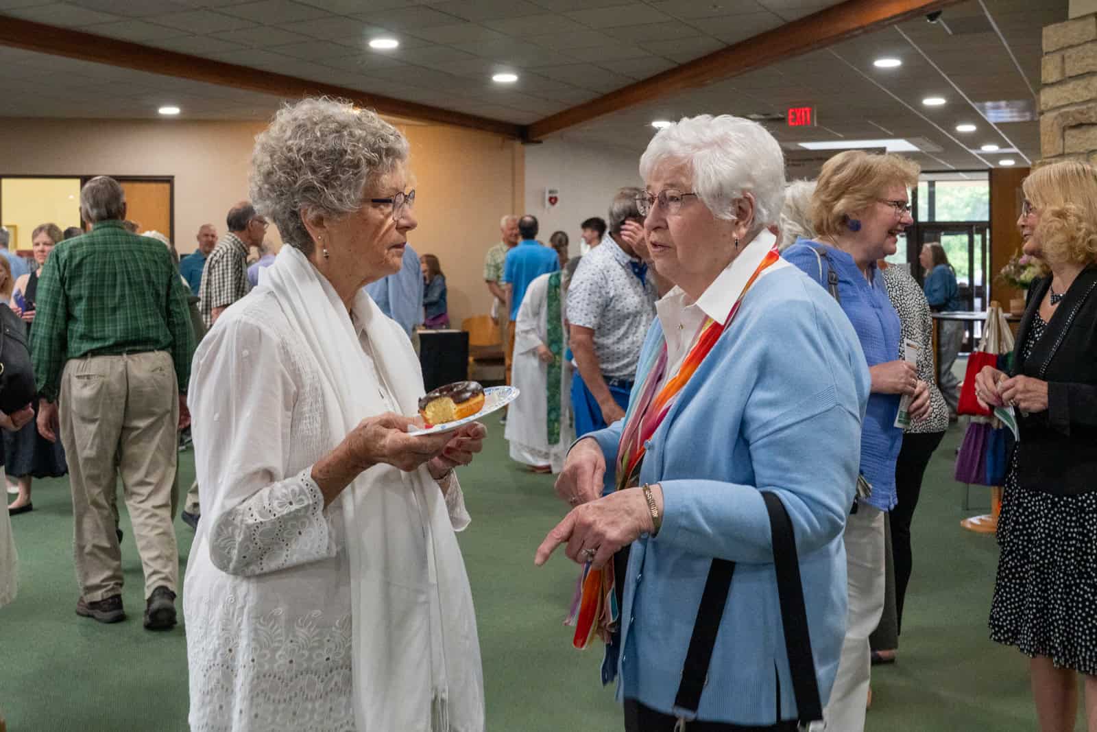 Senior women engaging in conversation at Incarnation Lutheran Church community event.